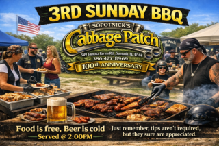 Outdoor daytime BBQ party at the Cabbage Patch Bar with bikers, families, motorcycles, and a grill full of smoked ribs and chicken for the 3rd Sunday BBQ event.